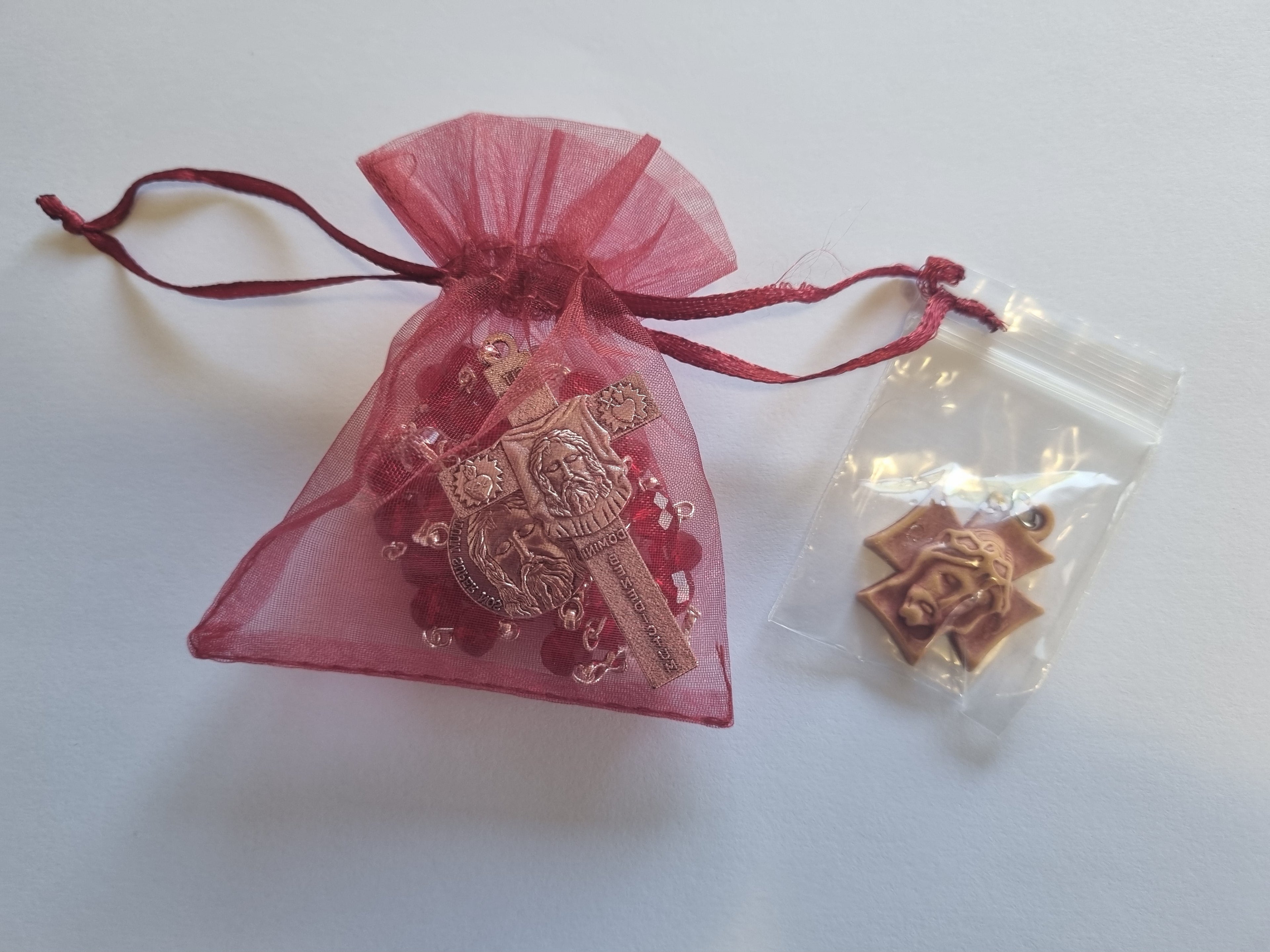 Decorative key pendant in a pink organza bag on a white background